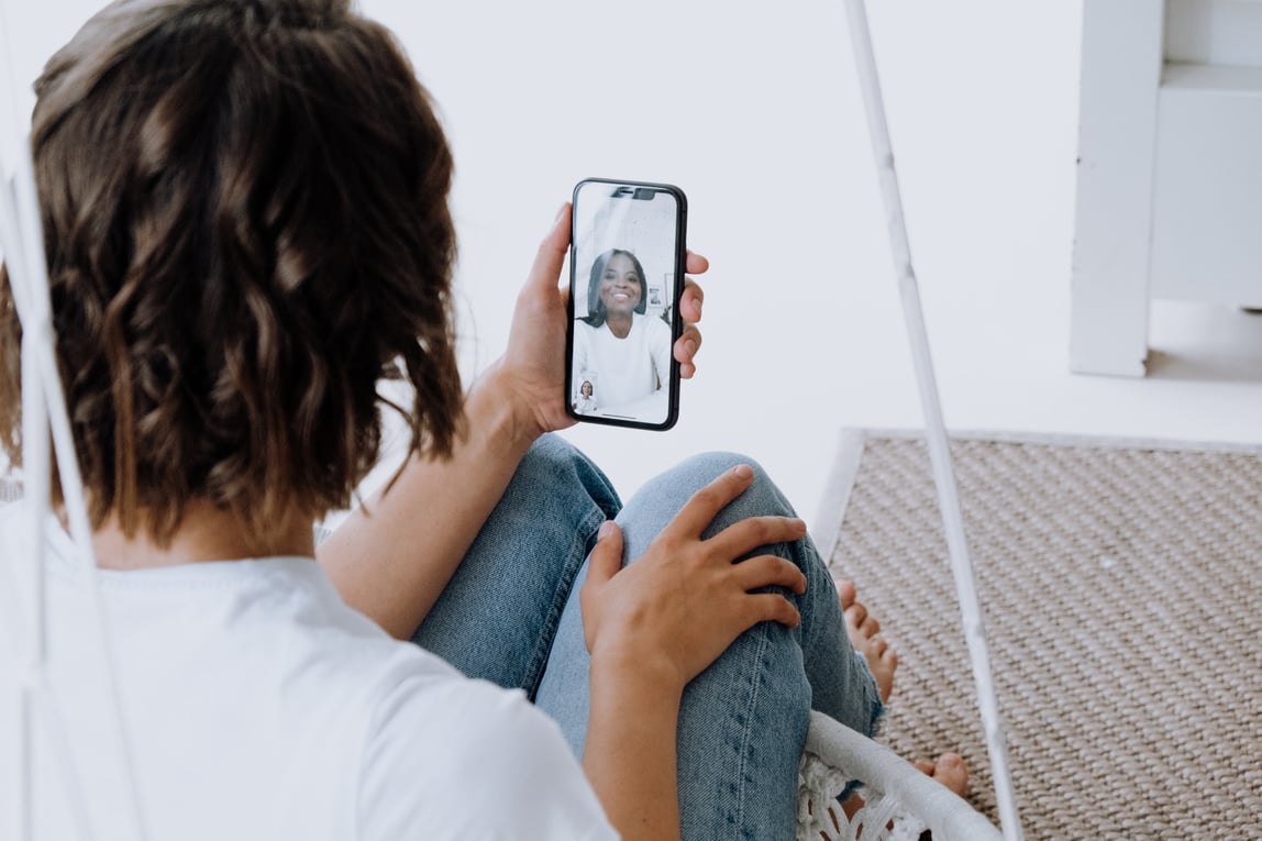 Woman in White Shirt Holding Iphone 6